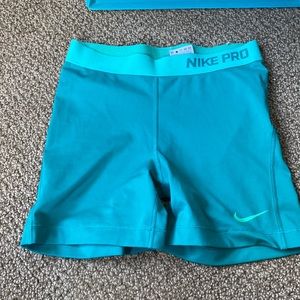 teal nike pros